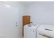 Functional laundry room featuring a washer, a dryer, and ample storage space at 1246 E Gary Ave, Las Vegas, NV 89123
