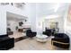 Open-concept living room featuring modern furniture, a fireplace, and an adjacent dining area at 1246 E Gary Ave, Las Vegas, NV 89123