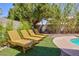 Relaxing poolside lounge area with comfortable chairs and lush landscaping, creating a private oasis at 1246 E Gary Ave, Las Vegas, NV 89123