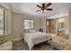Serene bedroom with an ensuite bathroom, tile flooring, and a cozy seating area at 1700 Red Rock St, Las Vegas, NV 89146