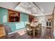 Bright dining room with a skylight, wood paneling, and access to a kitchen pass-through at 1700 Red Rock St, Las Vegas, NV 89146