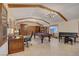 Spacious game room with a pool table, elegant chandeliers, and ample space for entertaining at 1700 Red Rock St, Las Vegas, NV 89146