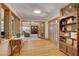 Hallway with natural light, hardwood floors, and decorative shelving leading to additional rooms at 1700 Red Rock St, Las Vegas, NV 89146