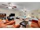 A living room featuring a large entertaining space with sofas, beds, and three ceiling fans at 1700 Red Rock St, Las Vegas, NV 89146