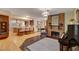 Open-concept living room featuring a brick fireplace, hardwood floors, and seamless flow to the kitchen at 1700 Red Rock St, Las Vegas, NV 89146