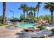 Resort-style pool surrounded by stone features, palm trees, and lush greenery at 1700 Red Rock St, Las Vegas, NV 89146