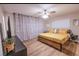 A bedroom featuring a bed with wood frame, ceiling fan and natural light at 2043 Sombrero Dr, Las Vegas, NV 89169