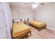 Bedroom with two beds, ceiling fan, and bright natural light at 2043 Sombrero Dr, Las Vegas, NV 89169