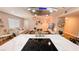 Modern kitchen view from above cooktop with stainless vent hood to living room decor at 2043 Sombrero Dr, Las Vegas, NV 89169
