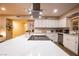 Bright, open kitchen with white cabinets, stainless appliances, and large center island cooktop at 2043 Sombrero Dr, Las Vegas, NV 89169