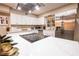 Bright kitchen featuring stainless steel appliances, white cabinets and a spacious center island at 2043 Sombrero Dr, Las Vegas, NV 89169