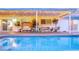 Relaxing outdoor covered patio with stylish furniture overlooking the refreshing in-ground pool at 2043 Sombrero Dr, Las Vegas, NV 89169