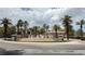 Water feature at community entrance surrounded by palm trees and lush landscaping at 2050 W Warm Springs Rd # 4211, Henderson, NV 89014