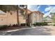 Exterior view of a well-maintained two-story building, surrounded by lush landscaping and mature trees at 2050 W Warm Springs Rd # 4211, Henderson, NV 89014