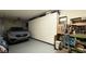 Organized garage featuring built-in cabinets, workbench, and a parked SUV, offering ample storage and utility at 2050 W Warm Springs Rd # 4211, Henderson, NV 89014