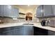 Close up of the kitchen with mosaic backsplash, blue cabinets, and stainless steel sink at 2050 W Warm Springs Rd # 4211, Henderson, NV 89014
