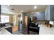 Bright kitchen featuring stainless steel appliances, blue cabinets, and open dining area at 2050 W Warm Springs Rd # 4211, Henderson, NV 89014