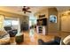 Open concept living room with wood floors, fireplace, and natural light at 2050 W Warm Springs Rd # 4211, Henderson, NV 89014