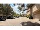 Street view of a community featuring well-maintained buildings, mature trees, and ample parking spaces at 2050 W Warm Springs Rd # 4211, Henderson, NV 89014
