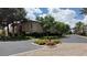 Landscaped corner with trees, fire hydrant, and building in a well-maintained community at 2050 W Warm Springs Rd # 4211, Henderson, NV 89014