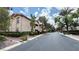 Street view featuring well-maintained multi-story buildings surrounded by mature trees and lush greenery at 2050 W Warm Springs Rd # 4211, Henderson, NV 89014