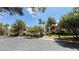 Street-level view of a residential complex showcasing manicured lawns, diverse trees, and well-maintained buildings at 2050 W Warm Springs Rd # 4211, Henderson, NV 89014