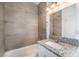 Modern bathroom features a granite vanity, shower with gray tiling and neutral tones at 2071 Idaho St, Pahrump, NV 89048