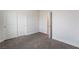 Neutral bedroom with soft carpet, white walls, closet, and door to another room at 2071 Idaho St, Pahrump, NV 89048
