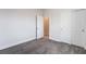 Bedroom with soft carpet, white walls, and closet, door leading to another room at 2071 Idaho St, Pahrump, NV 89048