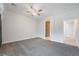 Spacious bedroom features neutral carpet and view into attached bathroom with shower at 2071 Idaho St, Pahrump, NV 89048