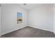 Bright bedroom featuring neutral carpet and a window offering outside views at 2071 Idaho St, Pahrump, NV 89048