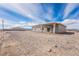 The backyard of the home, surrounded by desert landscape and blue skies at 2071 Idaho St, Pahrump, NV 89048