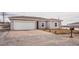 Charming single-story home with a two-car garage and desert landscaping at 2071 Idaho St, Pahrump, NV 89048