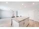 Open-concept kitchen island with granite countertop, white cabinets, and view to living area at 2071 Idaho St, Pahrump, NV 89048