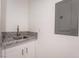 Laundry room features white cabinets with granite countertop and stainless steel faucet at 2071 Idaho St, Pahrump, NV 89048