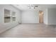 Spacious living room featuring wood floors, natural light and modern ceiling fan at 2071 Idaho St, Pahrump, NV 89048