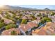 Beautiful aerial shot of a residential neighborhood showcasing well-maintained homes, lush trees, and mountain views at 2124 Rising Mist St, Las Vegas, NV 89134