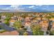 Overhead view of a residential neighborhood featuring charming homes, lush landscaping, and mountain scenery at 2124 Rising Mist St, Las Vegas, NV 89134