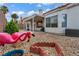 Whimsical backyard with desert landscaping, gravel, and pink flamingo decor at 2124 Rising Mist St, Las Vegas, NV 89134