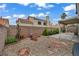Backyard landscaping featuring a rock garden, stepping stones, and desert plants at 2124 Rising Mist St, Las Vegas, NV 89134