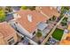 Aerial view of a backyard with a clay tile roof, covered patio, and gravel and artificial turf landscaping at 2124 Rising Mist St, Las Vegas, NV 89134