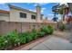 A charming backyard garden features colorful decorations, lush plants, and a serene ambiance at 2124 Rising Mist St, Las Vegas, NV 89134