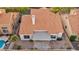 Aerial view of a backyard with a clay tile roof, covered patio, and gravel landscaping at 2124 Rising Mist St, Las Vegas, NV 89134