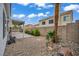 Backyard showcasing a rock garden with lush tropical landscaping and ample space at 2124 Rising Mist St, Las Vegas, NV 89134