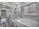 Bathroom showcasing a soaking tub, shower, and a stained glass window at 2124 Rising Mist St, Las Vegas, NV 89134