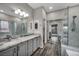 Sleek bathroom features a double vanity, walk-in glass shower, and modern fixtures at 2124 Rising Mist St, Las Vegas, NV 89134