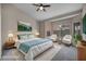 Virtually staged bedroom with a queen-sized bed, chairs, and natural lighting at 2124 Rising Mist St, Las Vegas, NV 89134