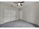 Neutral bedroom featuring gray carpeting, a ceiling fan, and a double closet at 2124 Rising Mist St, Las Vegas, NV 89134