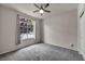 Bedroom with carpet, ceiling fan, a large window, and a closet door at 2124 Rising Mist St, Las Vegas, NV 89134