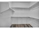 Walk-in closet with white walls, wooden floors, and multiple storage shelves at 2124 Rising Mist St, Las Vegas, NV 89134